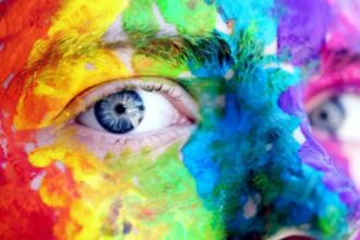 man with face painted with color