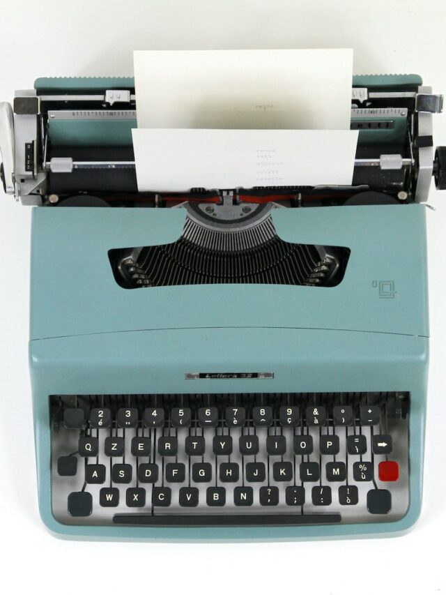 teal and black typewriter machine