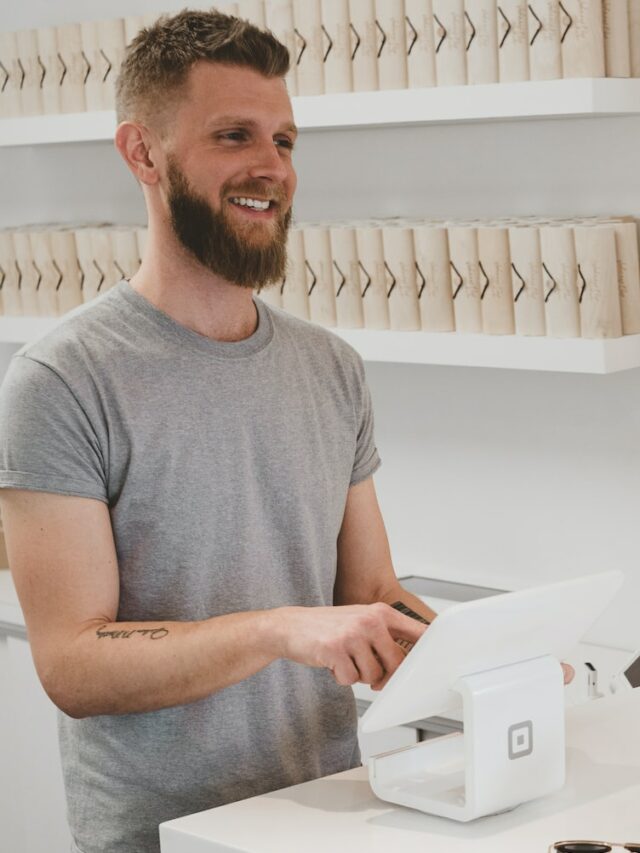 man in grey crew-neck t-shirt smiling to woman on counter