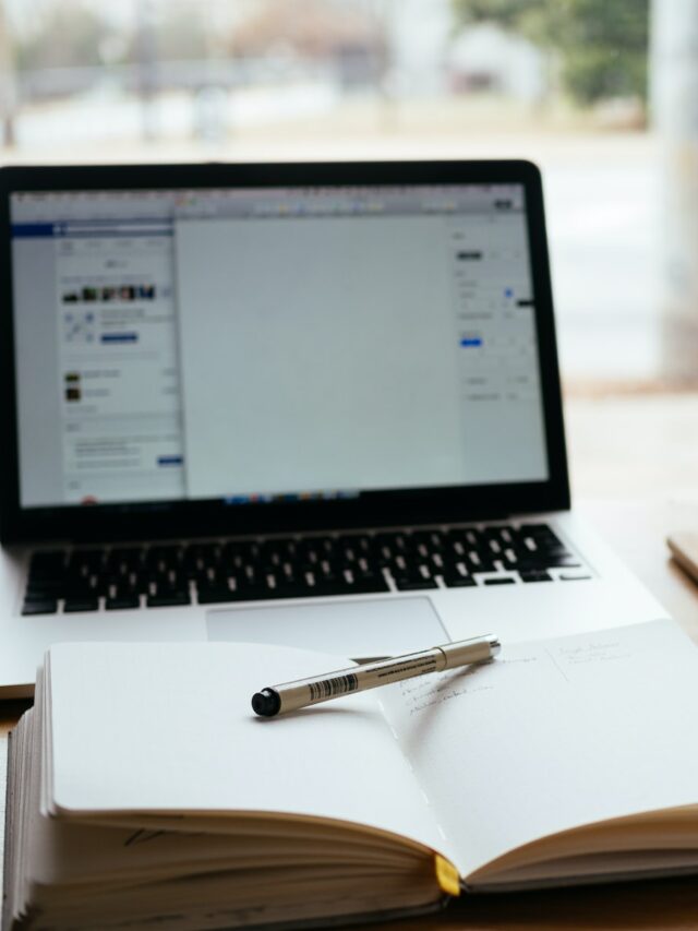 MacBook Pro near white open book