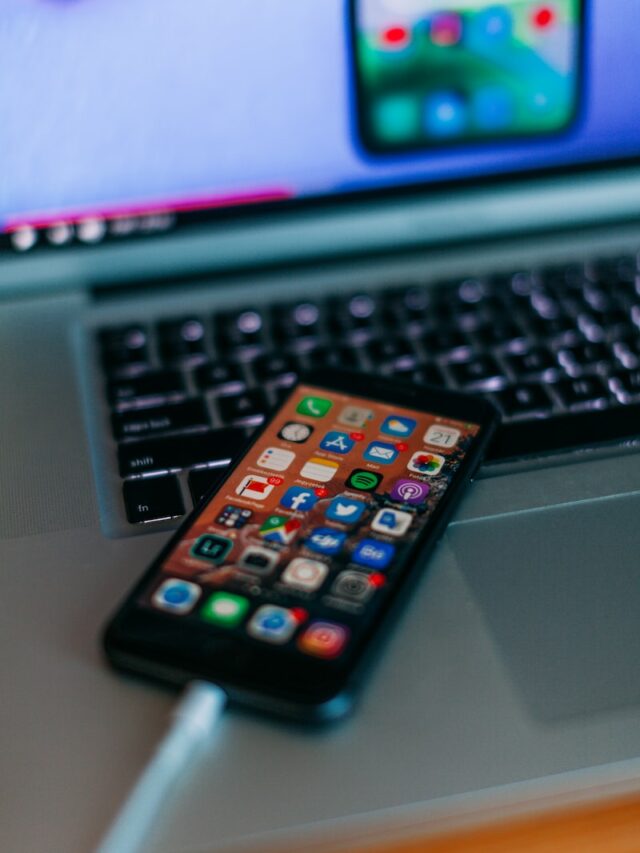 selective focus photography of iPhone on MacBook