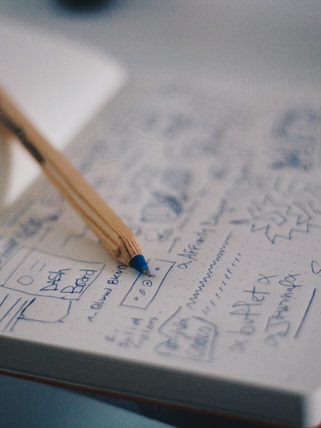 blue ballpoint pen on white notebook