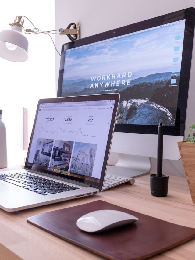 MacBook Pro on table beside white iMac and Magic Mouse