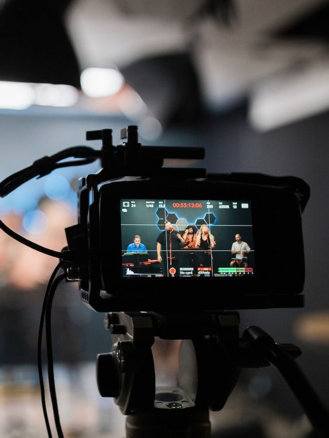 black dslr camera taking photo of city lights