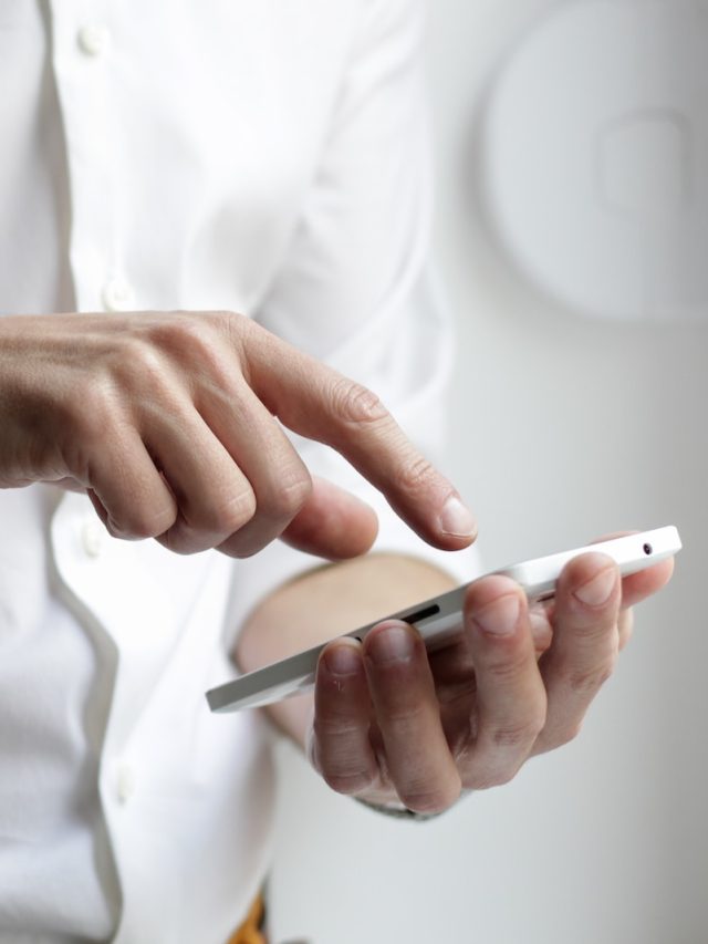 person holding white Android smartphone in white shirt