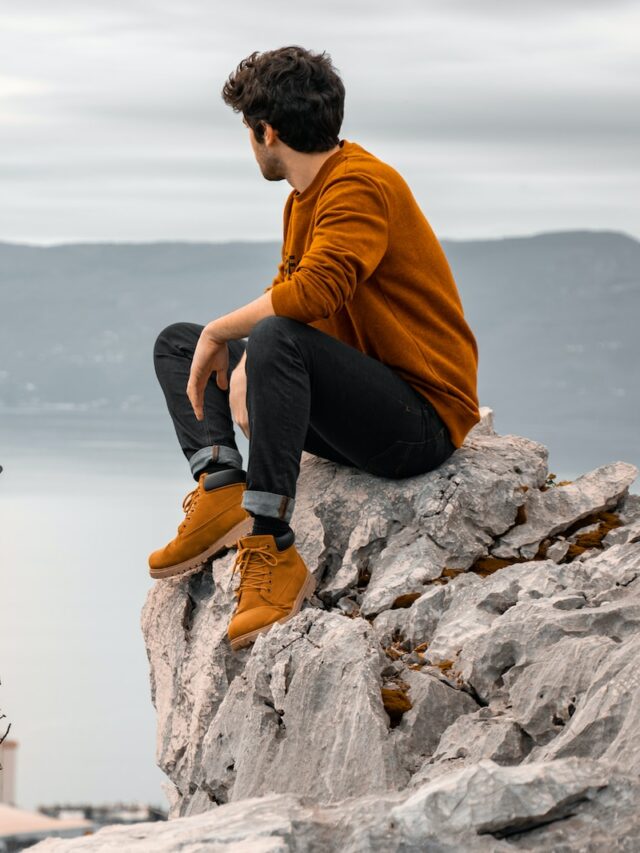 a man sitting on a rock