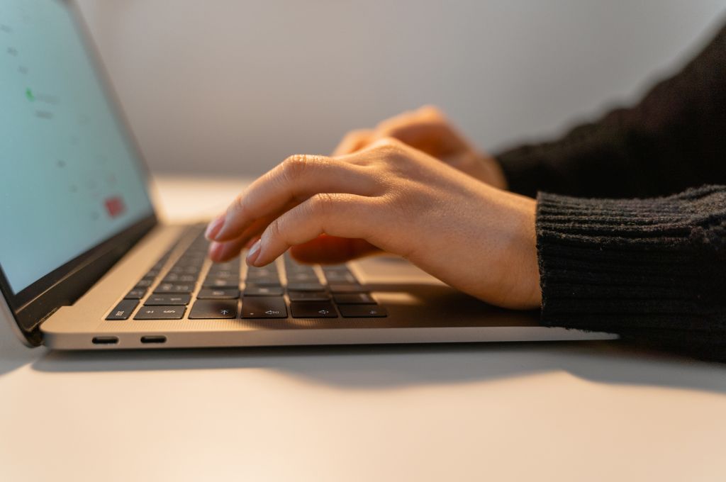 A person typing on laptop