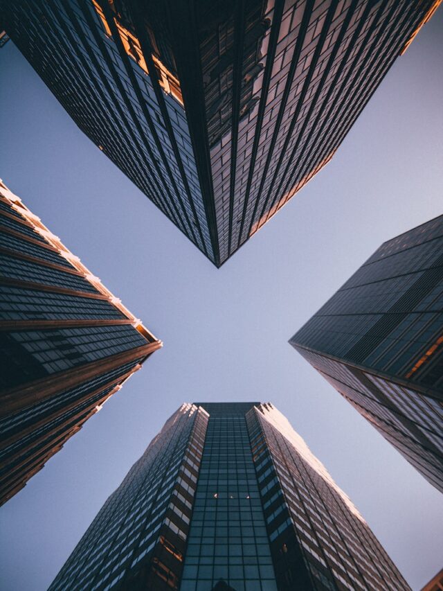low-angle photography of four high-rise buildings