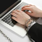 hands chained to laptop